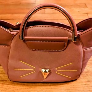 A very cute bag in faux suede accent body faux leather faux gold metal handles